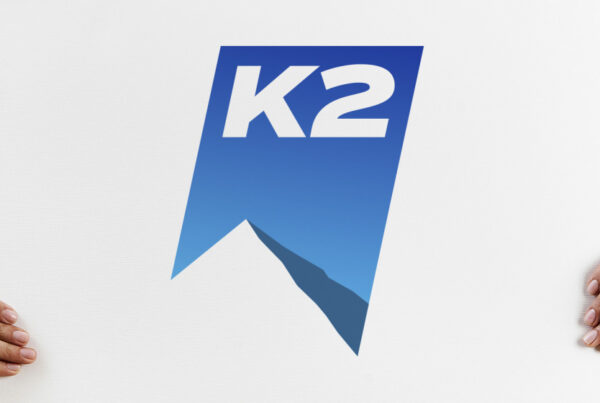 K2 logo on a board being held