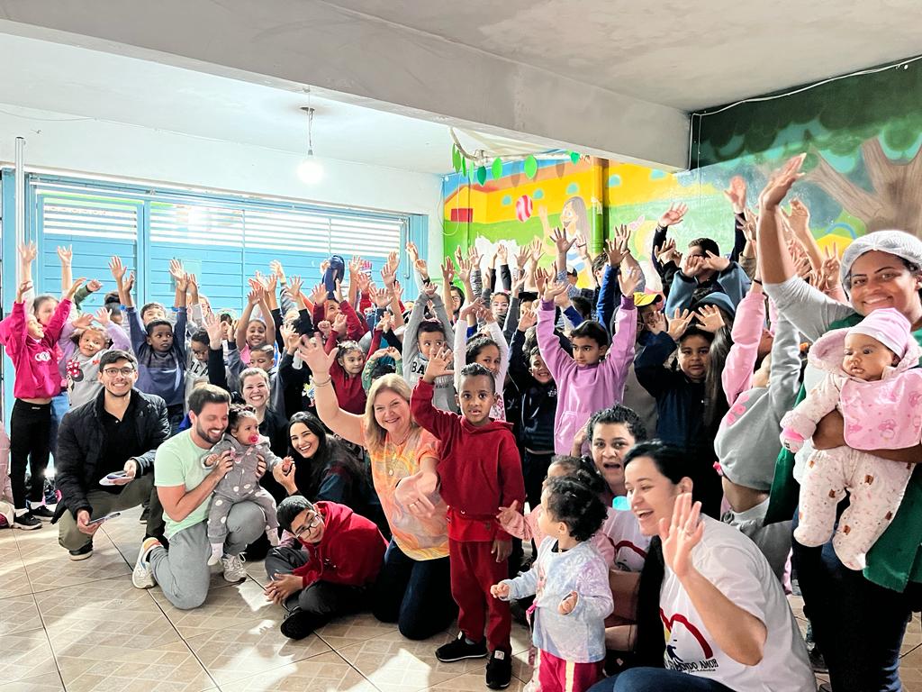 Children in Brazil school waving and smiling