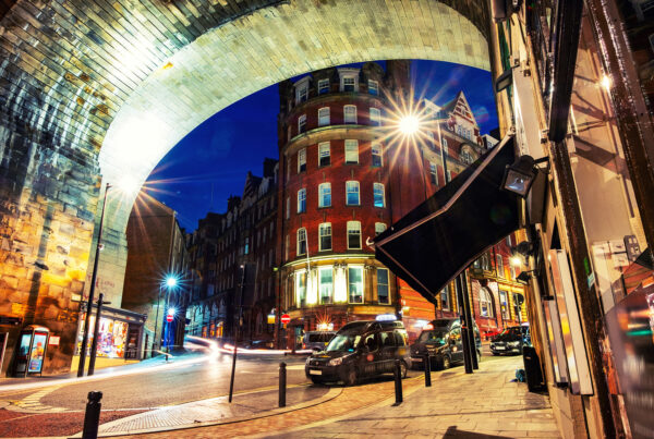 Night time street with taxis and archway