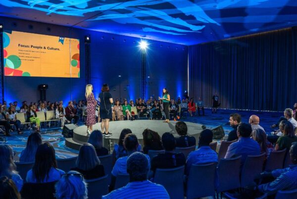 K2 team presenting on stage at the Kinetic conference