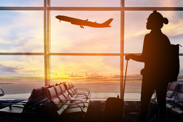 Lady at the airport with plane taking off