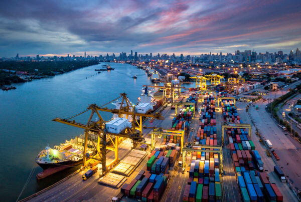 Aerial view of international port with Crane loading containers in import export business logistics