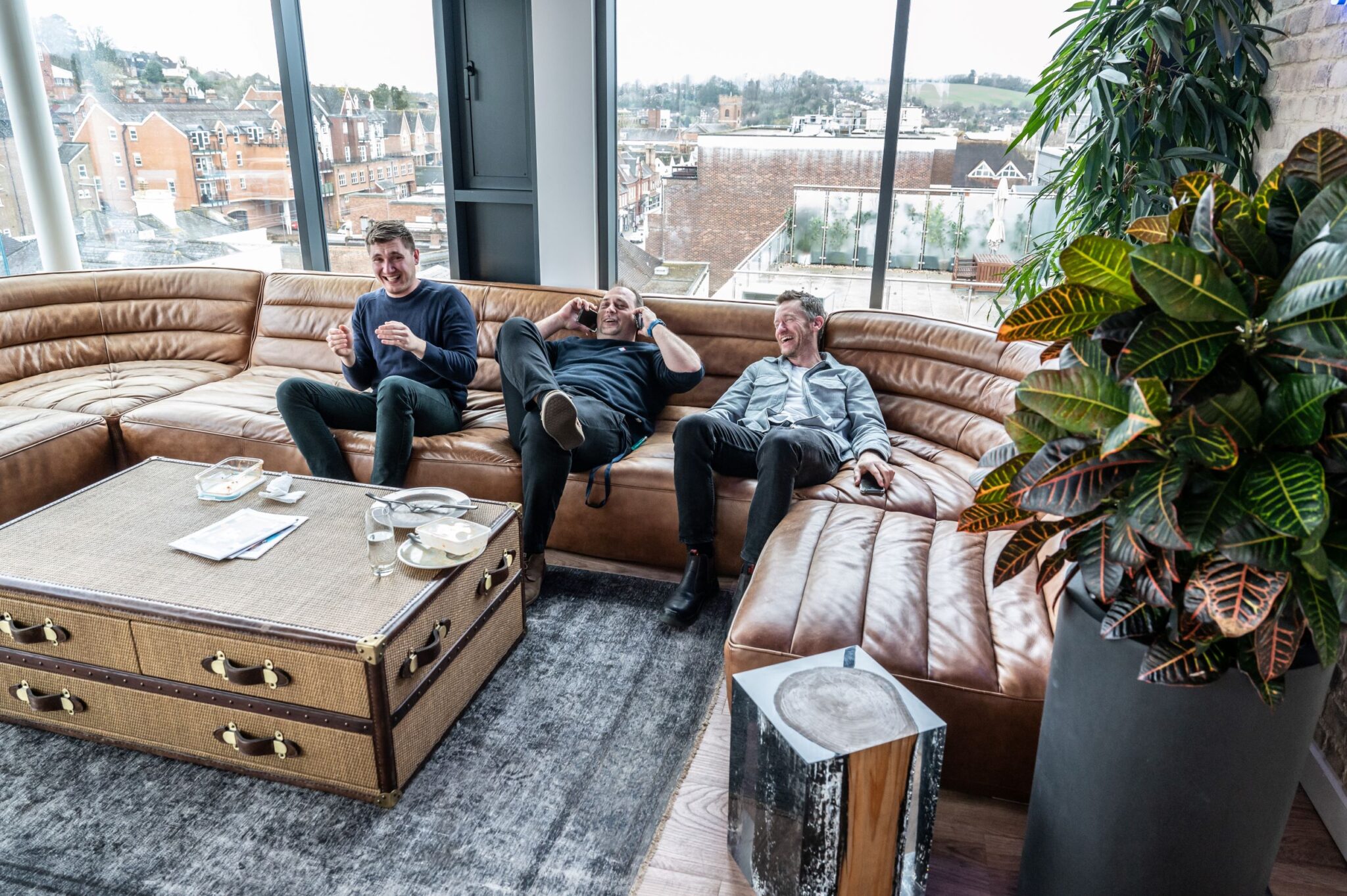 Three laughing men on the couch