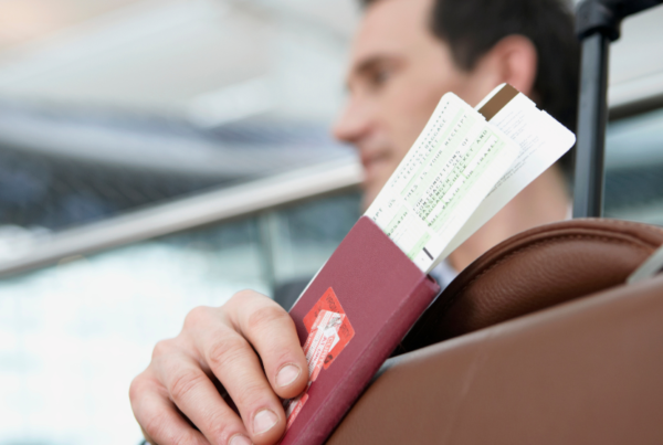 Man holding passport with boarding card