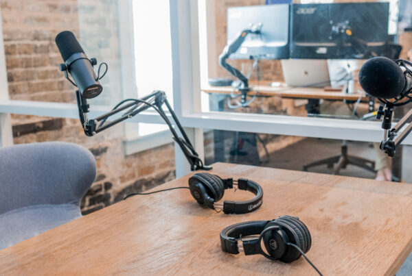 Podcast setup with microphones and headphones on a table