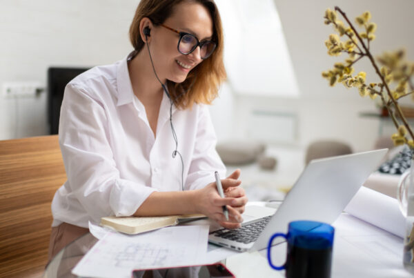 Lady with headphones looking at her laptop