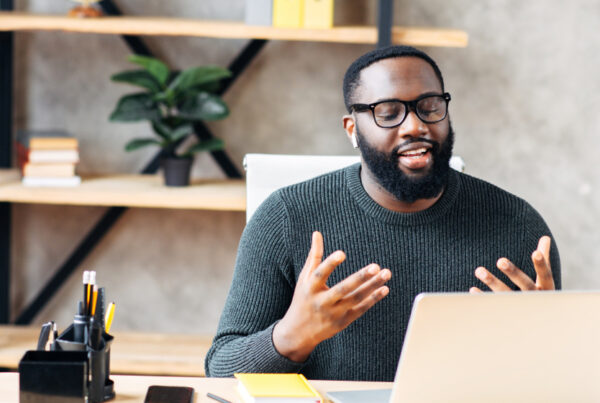 Man with glasses presenting on a video call
