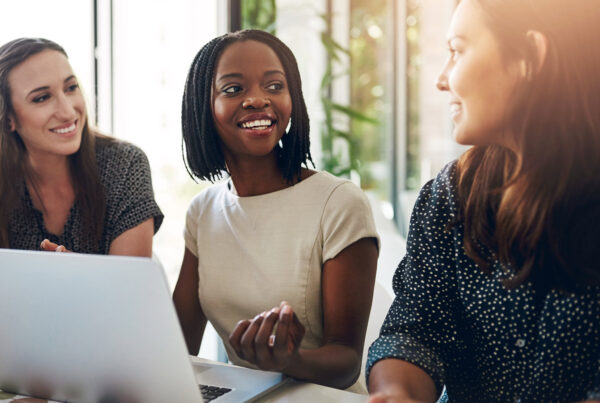 Group of laughing and smiling ladies at work