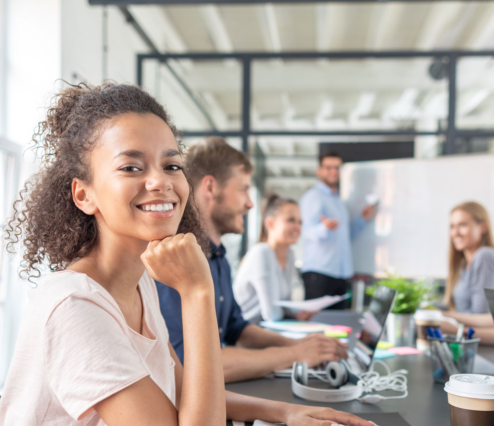 Young person working with a team in an office